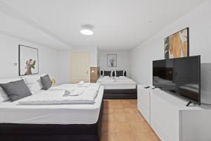 a living room with two beds and a flat screen tv at Big family apartment Berlin Treptower Park in Berlin
