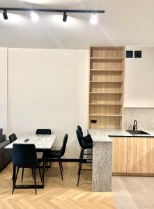 a kitchen with a table and chairs and a sink at Apartament Zdrojowy Zakątek in Busko-Zdrój