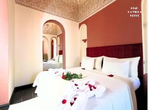 a hotel room with two beds with roses on them at Riad la villa bleue & SPA in Marrakesh