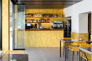 a restaurant with tables and chairs and a bar at Hostal La Cigüeña in Portinatx