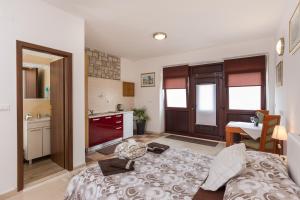 a living room with a bed and a kitchen at Apartments Dia in Dubrovnik