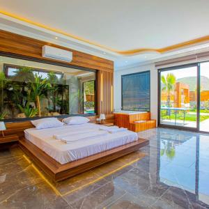 a large bedroom with a large bed and a pool at Villa Bahamas in Kas