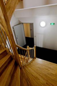 a stairway leading up to a dark room at Hôtel Saint Etienne in Lourdes