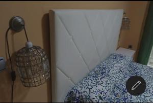 a bedroom with a bed with a lamp next to it at El MIRADOR DE LA PLAYA in Melilla