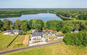 an aerial view of a large house with a lake at 2 Bedroom Amazing Home In Wilcze in Wilcze