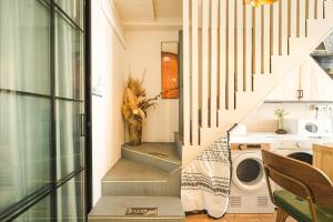 a stairway leading to a laundry room with a washing machine at Shanghai River View Villa in Shanghai