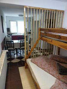 a bedroom with a bunk bed and a dining room at Vila Cri Cri in Buşteni