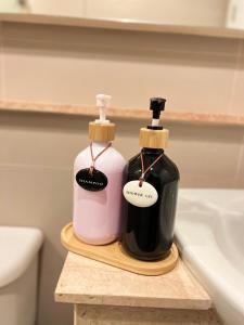 two bottles of soap sitting on top of a bathroom sink at I chill Six Room in Ban Bang Saen (1)