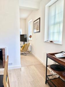 a living room with a desk and a chair at Detached Pet Friendly Cottage, 2 parking spaces in Norwich