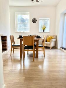 a dining room table and chairs in a living room at Detached Pet Friendly Cottage, 2 parking spaces in Norwich