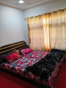Ein Bett oder Betten in einem Zimmer der Unterkunft MAGRAY GUEST HOUSE
