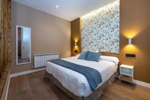 una camera da letto con un letto grande e una grande finestra di Apartamentos LA CAÑADA DE OSMA a El Burgo de Osma Altre 59 foto