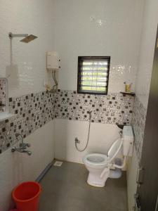 a bathroom with a toilet and a sink at SHRISHAILAM FARM AND YATRI NIWAS in Akalkot