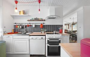 a kitchen with white cabinets and white appliances at Beautiful Home In Gilleleje With Wifi in Gilleleje