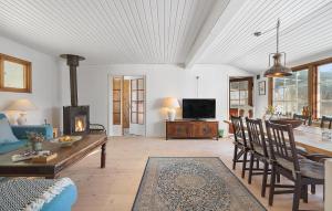 a living room with a table and a fireplace at Beautiful Home In Gilleleje With Wifi in Gilleleje
