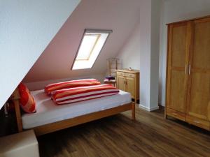 ein Schlafzimmer mit einem Bett mit Kissen und einem Fenster in der Unterkunft Seaside - ABC415 in Wismar