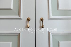 a close up of a door with gold handles at Al centro Luxury Home in Caserta