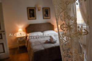 a bedroom with a bed and a curtain at Al centro Luxury Home in Caserta