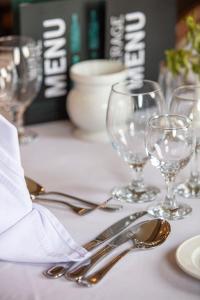 a white table with silverware and wine glasses on it at Jaz Celebrity Nile Cruise - Every Saturday from Luxor for 07 & 04 Nights - Every Wednesday From Aswan for 03 Nights in Luxor