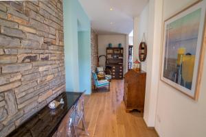 a living room with a stone wall at Sunset View by Firenze Prestige in Quercianella