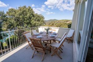 a table and chairs on a balcony with a view at Sunset View by Firenze Prestige in Quercianella