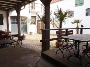 an outdoor patio with tables and chairs and a table at Lodge am Oxenweg in Husum