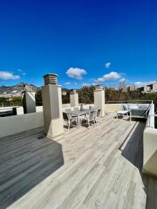a patio with tables and chairs on a roof at Luxury Condo Sea View Large Terrace BenalBeach in Benalmádena +10 photos