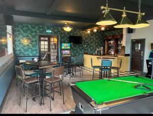 a bar with a pool table in a restaurant at The Wheatley Hotel in Doncaster