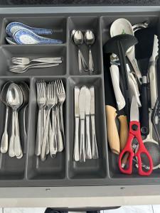 a tray filled with utensils and silverware at City Apartment 1 in Brühl