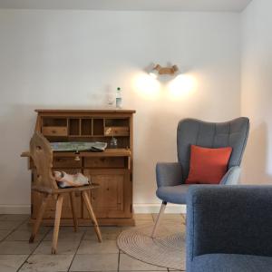 a room with a desk and a chair and a table at Gästehaus Hotel Maria Theresia - Kennenlernpreise für den Frühling am Schliersee in Schliersee