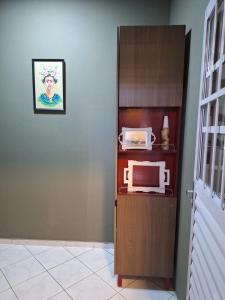 a microwave sitting on top of a cabinet in a room at Casa Frida 1 in Natal