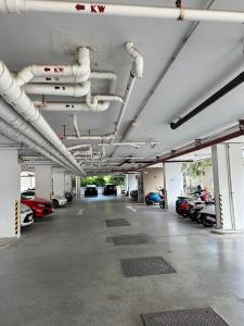 a large parking lot with cars parked in it at I chill Six Room in Ban Bang Saen (1)