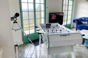 a room with a foosball table and a camera at Villa des Suisses with Jacuzzi & View of Lake des Settons in Moux-en-Morvan