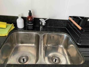 a stainless steel sink in a kitchen with a stove at Moderno y luminoso in Buenos Aires
