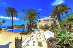 a resort with a pool and palm trees at Tropicalidays Oceanview Chayofa in Chayofa