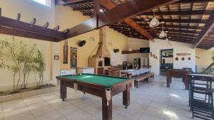 a large room with a pool table in it at Espetacular, 6 suítes, Varanda Gourmet, Bilhar, Pebolim, Praia dos Sonhos in Itanhaém