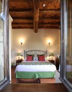 A bed or beds in a room at Capannelle Wine Resort