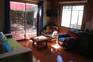 a living room with two chairs and a table at Ruka Experience in Pucón