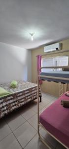 a room with two bunk beds and a window at Casa em Caldas Novas in Caldas Novas
