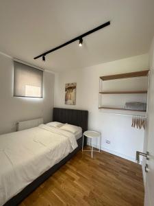 a bedroom with two beds and a table in it at Vulkan lux in Zemun