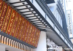 a row of signs on the side of a building at APA Hotel Namba Shinsaibashi Nishi in Osaka