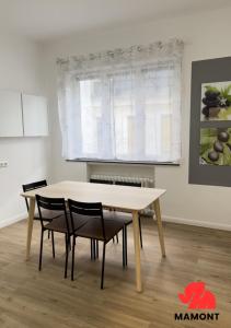 a table and chairs in a room with a window at Schöne, große Monteurwohnung in Bremen
