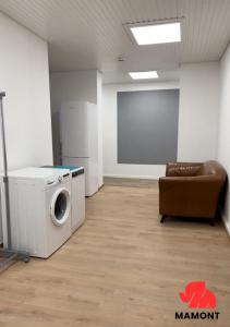 a room with a washing machine and a chair at Space Comfort Bremen Apartment bis zu 7 Personen in Bremen +2 photos