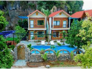 a house with a swimming pool in front of it at Tam Coc Green Mountain Homestay in Ninh Binh +13 photos