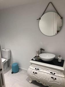 Baño blanco con lavabo y espejo en Loft LVU en Zaragoza, en Zaragoza
