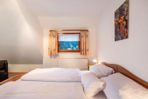 托特莫斯的住宿－Haus Johanna，一间卧室设有两张白色的床和窗户