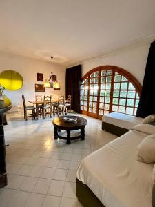 a bedroom with a bed and a table and a dining room at Villa Le Palme in Ischia