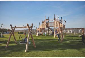 a group of children playing in a playground at Newland's in Rochester