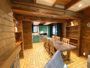a kitchen and dining room with a table and chairs at LE RENARD Chalet en bois in La Bresse