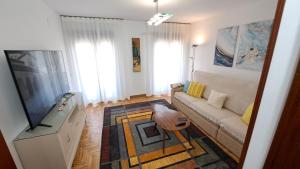 a living room with a couch and a flat screen tv at Granada Home Center in Granada
